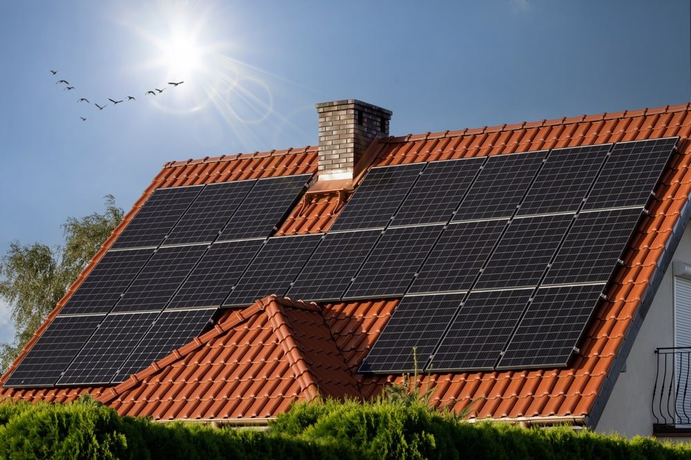 Black solar panels on a tiled roof min